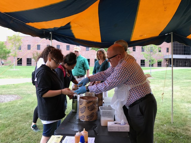 President Rodney Hanley scooping ice cream for students